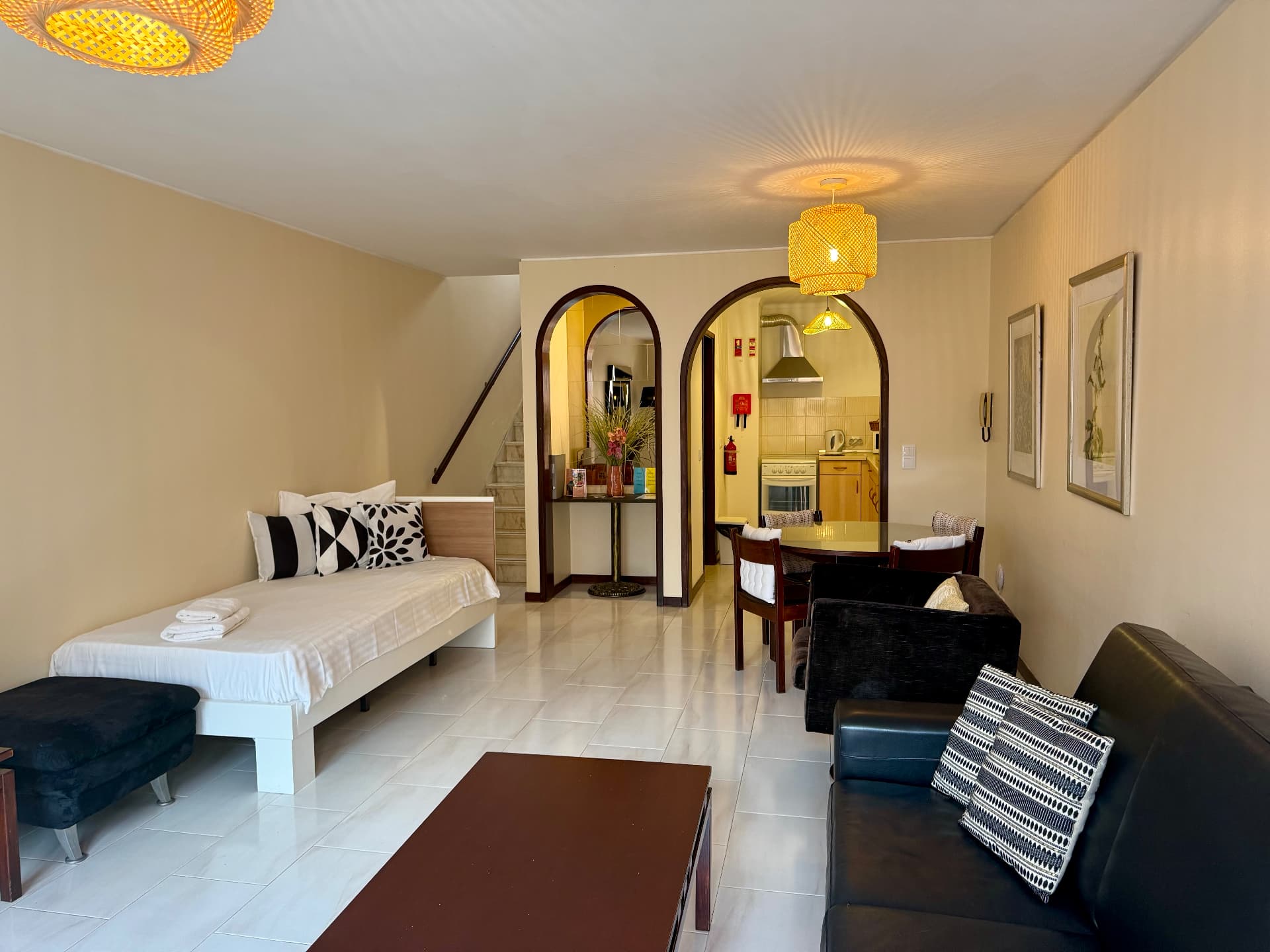Open-plan Family Villa interior with daybed, sofa and staircase