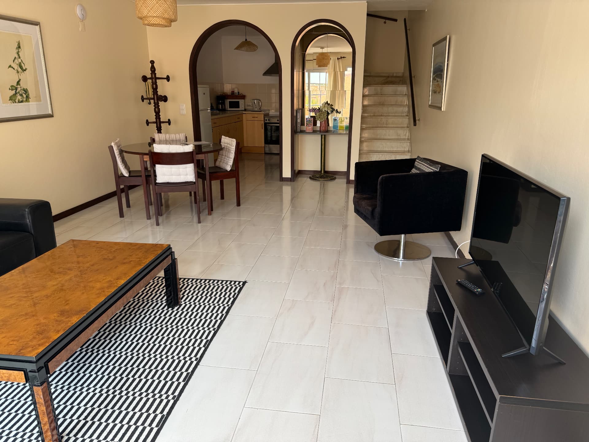 Classic Villa living room with television and staircase